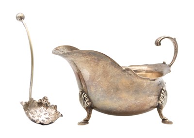 Lot 196 - A Victorian silver sauce boat by Barker Brothers, with a silverplated sifter spoon.