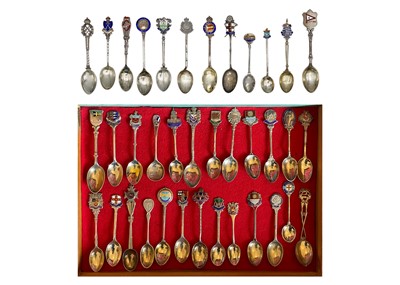 Lot 203 - A collection of British silver and enamel souvenir teaspoons.