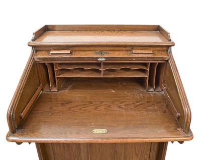 Lot 461 - An oak narrow roll top desk.