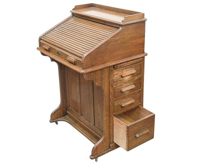 Lot 461 - An oak narrow roll top desk.
