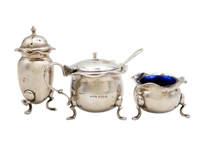 Lot 288 - A George V silver three-piece cruet set with a spoon.