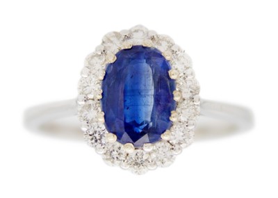 Lot 133 - An 18K white gold oval blue kyanite and diamond halo ring.