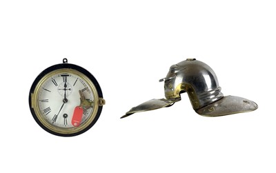 Lot 64 - A painted and brass mounted bulkhead wall clock and a Roman style helmet.