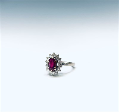 Lot 2585 - An 18ct white gold ruby and diamond oval...