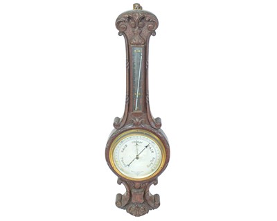 Lot 152 - A Negretti & Zambra carved oak aneroid barometer.