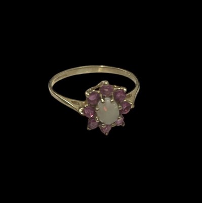 Lot 18 - A 9ct gold dress ring set with rubies and an...