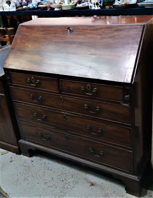 Lot 3421 - A George III mahogany bureau, the fall front...