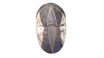 Lot 19 - A carved wood African mask.