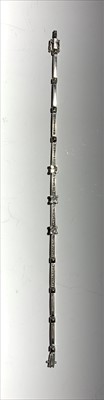 Lot 2534 - A 9ct white gold and diamond line bracelet.