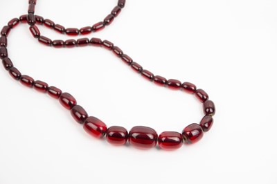 Lot 273 - A bakelite cherry 'amber' graduated bead necklace.