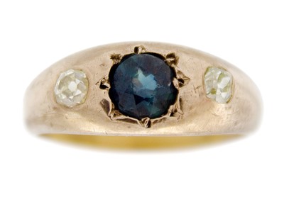 Lot 140 - A blue sapphire and yellow old European cut diamond three-stone gypsy set ring.