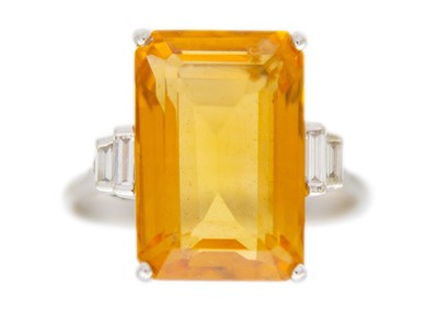 Lot 105 - An orange citrine and diamonds 18k white gold dress ring.