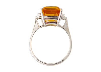 Lot 105 - An orange citrine and diamonds 18k white gold dress ring.