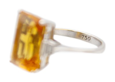 Lot 105 - An orange citrine and diamonds 18k white gold dress ring.