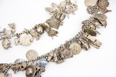 Lot 294 - Two silver and white metal charm bracelets.