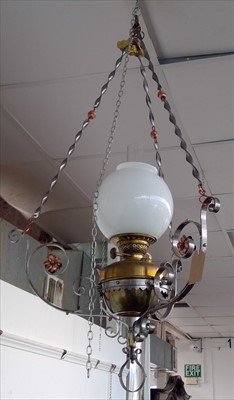 Lot 82 - A hanging oil lamp, the wrought metal frame...