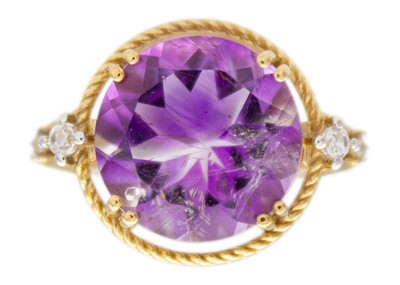 Lot 119 - A 9k gold amethyst and zircon dress ring.