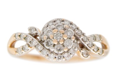 Lot 121 - A 9k rose gold diamond cluster ring.