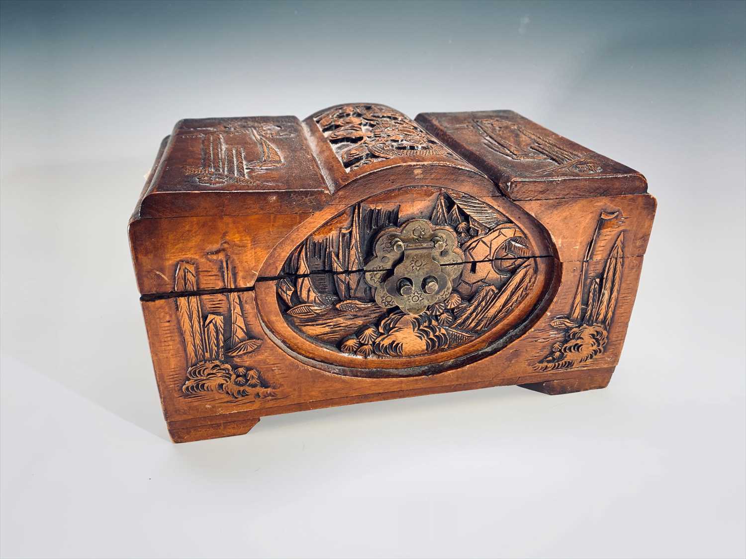 Lot 715 - A Chinese carved camphor wood miniature chest,...