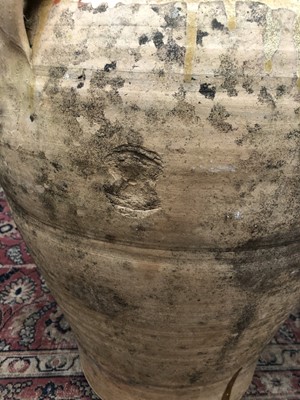 Lot 240 - A large terracotta olive jar with three loop...