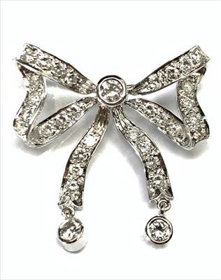 Lot 2590 - A good 18ct white gold post war bow brooch set...