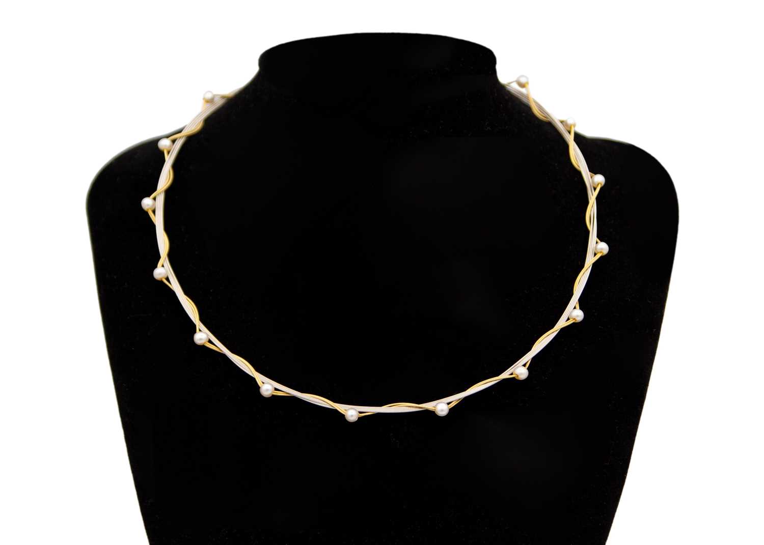 Lot 198 - A modern 18k yellow and white gold wire pearl applied 16" necklace.