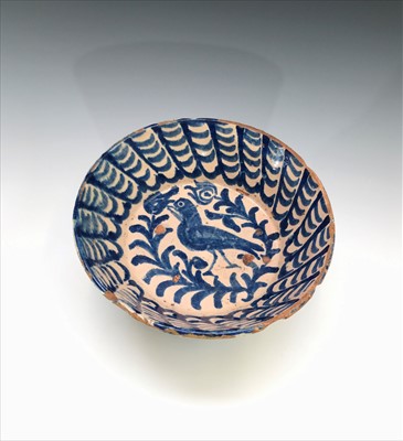 Lot 1031 - A Spanish majolica bowl painted with a bird...