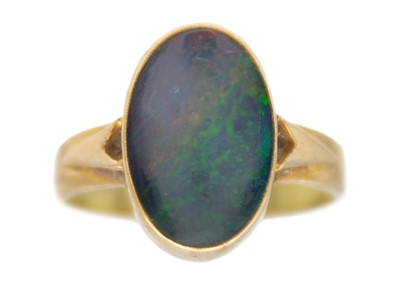 Lot 211 - An opal triplet solitaire ring in 9k yellow gold.