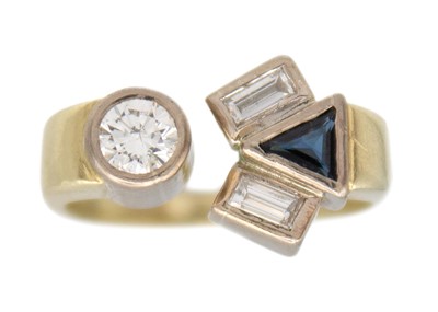 Lot 216 - A diamond and sapphire abstract ring in 14k two-tone gold.