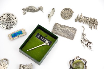 Lot 303 - A collection of thirteen pewter brooches and a Piran Pewter pendant necklace.