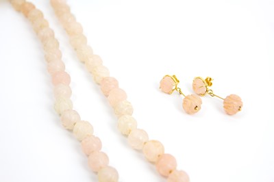 Lot 314 - A rose quartz round carved bead necklace and earrings suite, with 14k mounts.