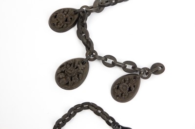 Lot 296 - A Victorian Whitby jet necklace with three oval carved pendants.