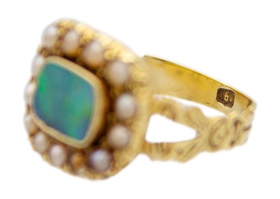 Lot 104 - An early 19th-century mourning ring with an opal replacement.