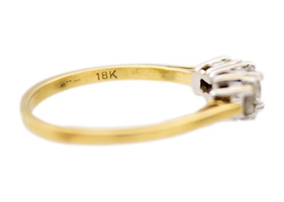 Lot 245 - An 18k yellow gold three-stone diamond ring.