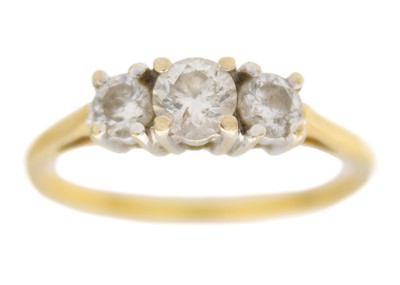 Lot 245 - An 18k yellow gold three-stone diamond ring.