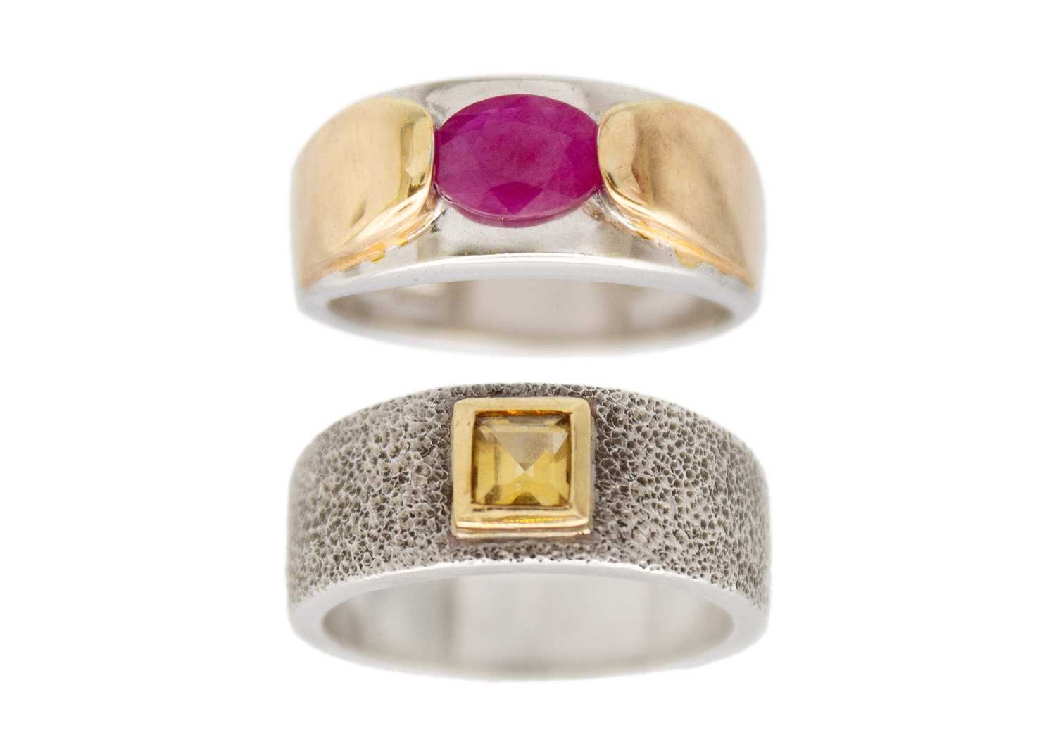 Lot 27 - A selection of two silver gem band rings.