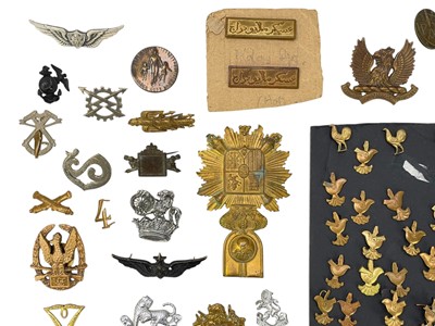 Lot 569 - A collection of assorted foreign cap badges.