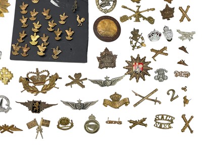 Lot 569 - A collection of assorted foreign cap badges.