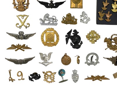 Lot 569 - A collection of assorted foreign cap badges.