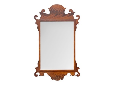 Lot 334 - A George III style flame mahogany fretwork wall mirror.