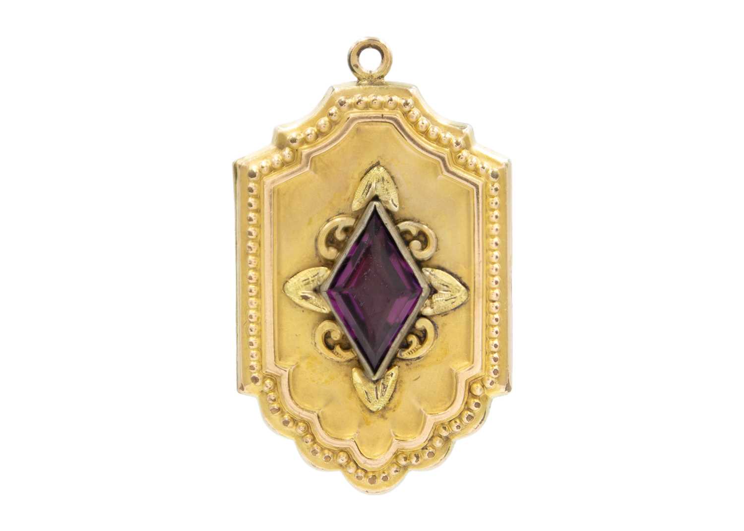 Lot 19 - A gold-plated purple paste set locket fob.