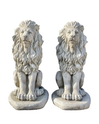 Lot 382 - A pair of reconstituted stone garden sculptures of seated lions.