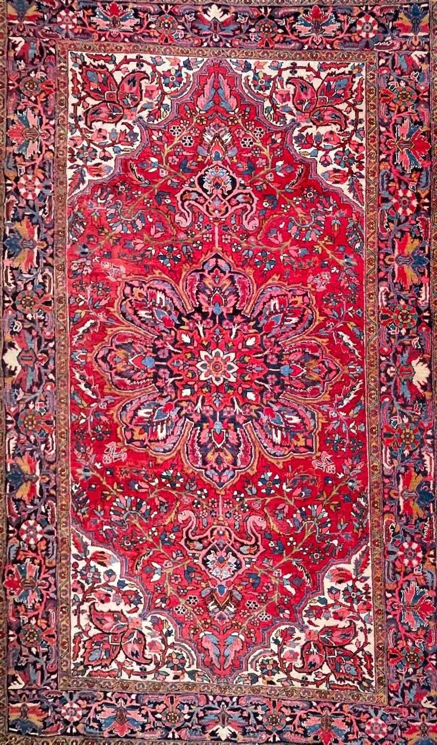 Lot 616 - A Persian Heriz carpet.