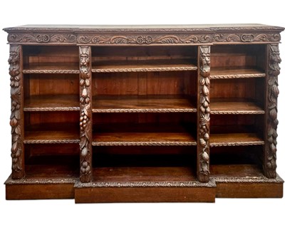 Lot 401 - A Victorian carved oak breakfront open low bookcase.