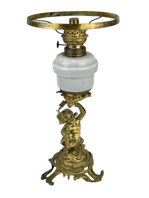 Lot 61 - A 19th century gilt brass cherub oil lamp.