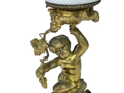 Lot 61 - A 19th century gilt brass cherub oil lamp.