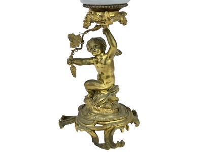Lot 61 - A 19th century gilt brass cherub oil lamp.