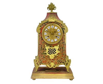 Lot 395 - A French ormolu mounted brass and tortoiseshell boule mantel clock.