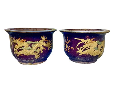 Lot 369 - A near pair of Eastern pottery planters.