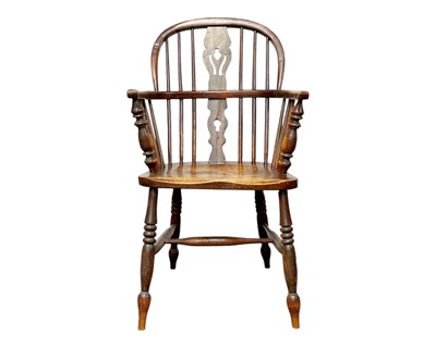 Lot 338 - A Victorian fruitwood and ash Windsor elbow chair.